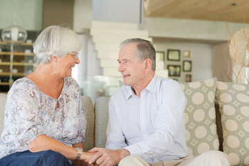 Couple relaxing on sofa together