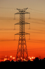 Electrification tower with late afternoon orange sky.