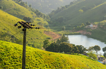 Rural electrification pole in the countryside with lake and mountains in the background, in Areia, Paraiba, Brazil on September 14, 2004.