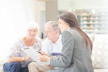 Financial advisor talking to couple on sofa