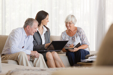 Financial advisor using tablet computer with clients