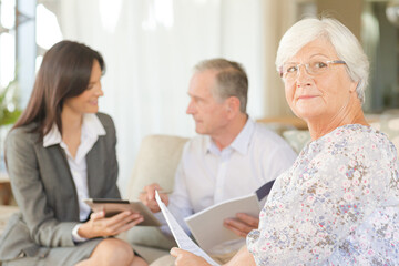 Financial advisor using tablet computer with clients