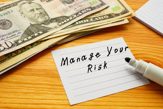  Manage Your Risk inscription on the piece of paper.