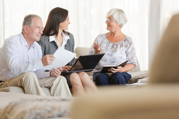 Financial advisor using tablet computer with clients