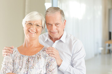 Older couple smiling together indoors