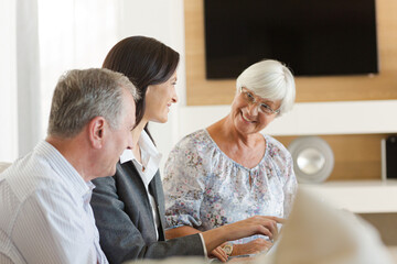 Financial advisor sitting on sofa with clients