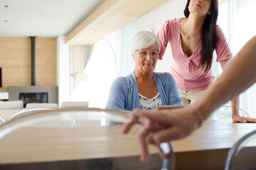 Women using tablet computer at table