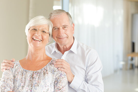 Older couple smiling together indoors