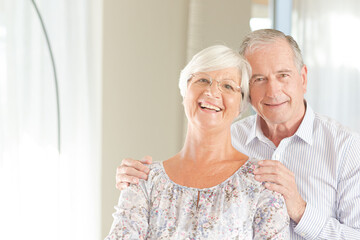 Older couple smiling together indoors