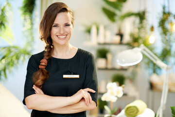 Portrait of happy woman worker in modern beauty salon