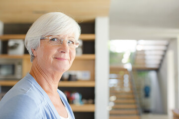 Older woman in living room, smiling