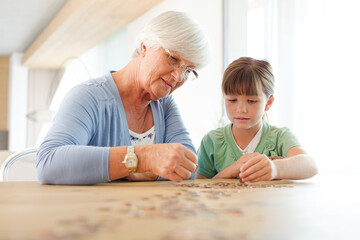 Older woman and granddaughter counting pennies