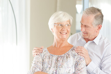 Older couple smiling together indoors
