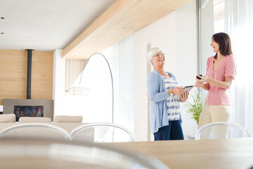 Fototapeta premium Mother and daughter posing with computer tablet
