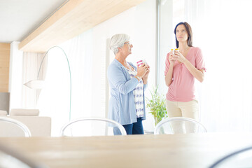 Fototapeta premium Mother and daughter having cup of coffee