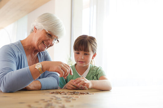 Older woman and granddaughter counting pennies
