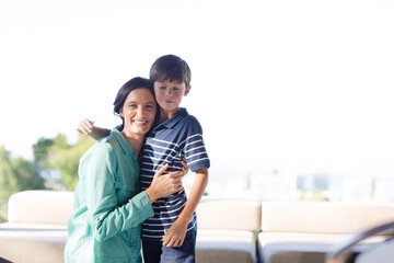 Mother and son hugging outdoors