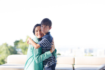 Mother and son hugging outdoors