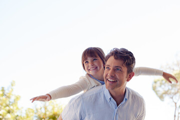 Father and daughter hugging outdoors