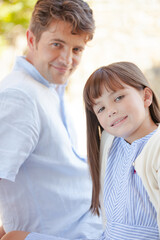 Fototapeta premium Father and daughter smiling outdoors