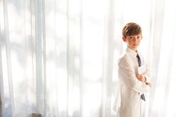 Boy in shirt and tie holding tablet computer