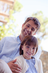 Father and daughter hugging outdoors