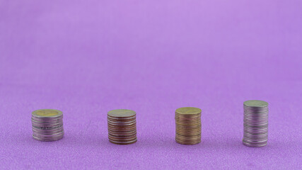 Row of coins thai baht isolated on purple paper background