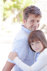 Father and daughter hugging outdoors