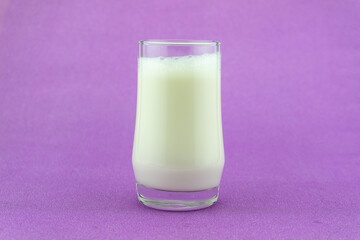 Banner of a glass of milk on colorful background Milk day Copy space