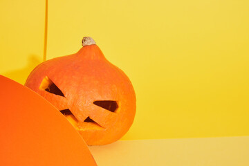 pumpkin jack lantern on yellow and orange background, copy space, halloween decoration concept