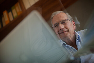 Fototapeta premium Older man working at desk