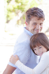 Fototapeta premium Father and daughter hugging outdoors