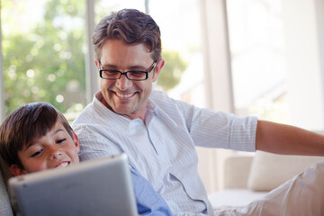 Fototapeta premium Father and son using tablet computer
