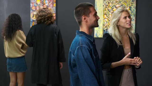 connoisseurs of art are visiting modern art gallery with exhibit of trendy artist