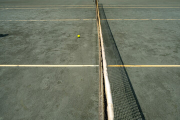Tennis court with tennis ball on ground