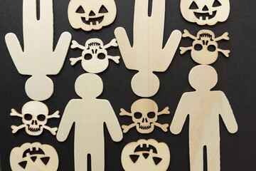 wooden silhouettes with laser cut-scary monster masks and skull and bones on a dark background