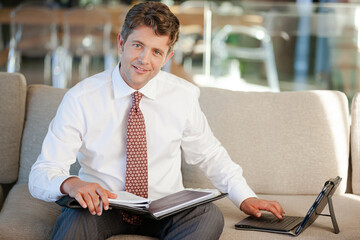 Businessman smiling on sofa