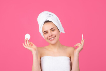 Closeup face of beautiful young smiling woman with bath towel on head. Beautiful woman face isolated on studio. Natural cosmetics and skincare. Beautiful woman woman in spa salon.