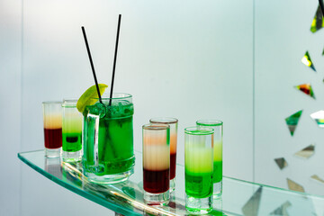 Green cocktail with lemon. Multicolored summer cocktails.