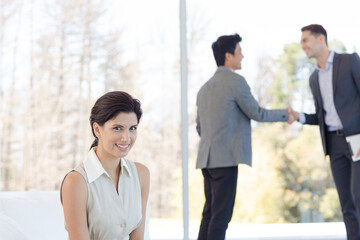 Businessmen shaking hands in office