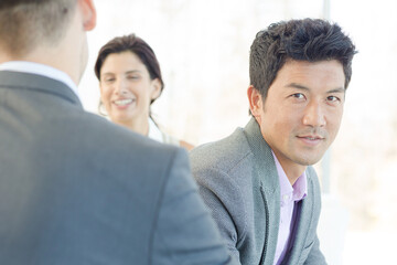 Businessmen smiling in office