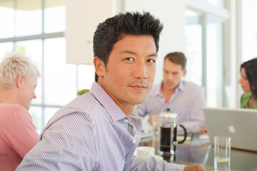 Businessmen smiling in office