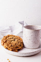 Oatmeal cookies on a ceramic set on a white surface
