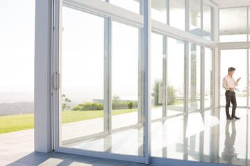 Businessman standing at office window