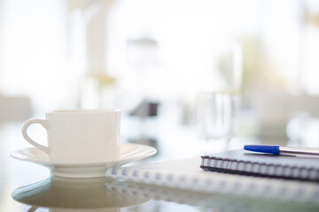 Coffee cup and water glass on meeting table
