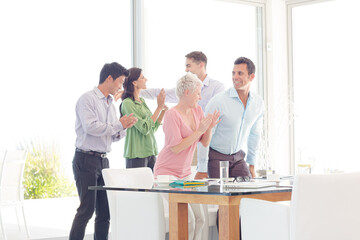 Business people cheering in office