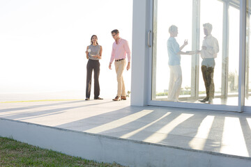 Business people talking outside office