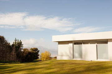 Modern house casting shadows on manicured lawn