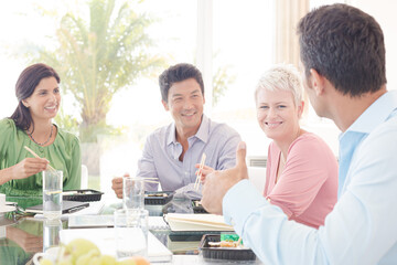Business people smiling in lunch meeting