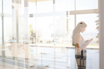 Businesswoman using cell phone in office
